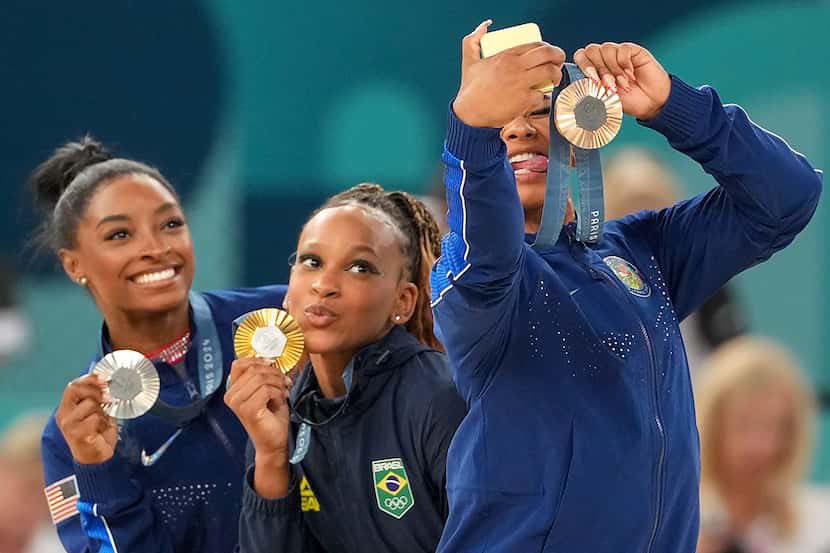 Gold medalist Rebeca Andrade of Brazil celebrates on the podium with silver medalist Simone Biles of the United States and bronze winner Jordan Chiles also of the US. Photo by: Alexandre Loureiro/COB